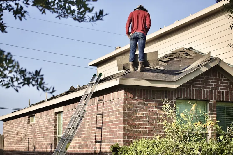 Professional roofer working on a residential roof in Kernville
